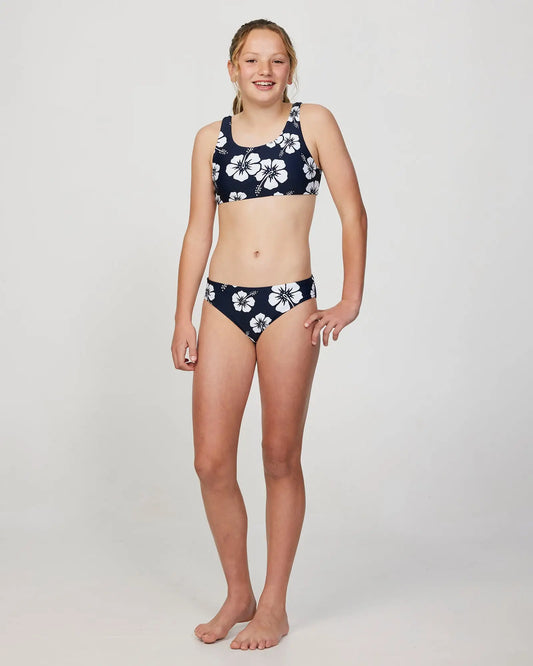 Full body front view of a girl model wearing the Okanui Crop Bikini Set in Hibiscus Navy