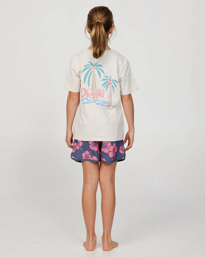 full body back view of a little girl model wearing the Okanui swim short for girls in Hibiscus Iron Pink