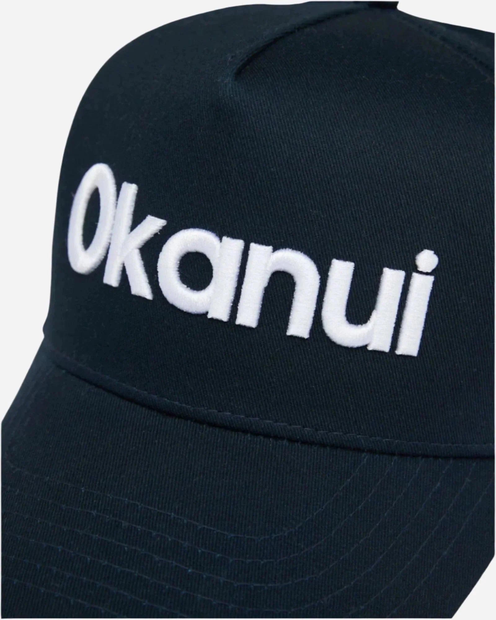 Closeup view of the Okanui Snapback Trucker Cap Logo in Navy Color