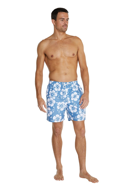 A male model wearing the Okanui Mens Swim Shorts featuring a Hibiscus flower print pattern in Steel color.