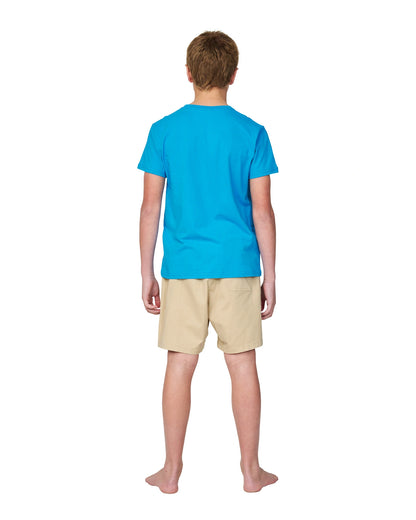 Full body back view of a boy wearing the Okanui Logo tee T-shirt in Washed Blue