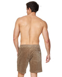 A model posing and wearing the Okanui Big Iron Cord Walkshorts in stone colour as seen from the back.