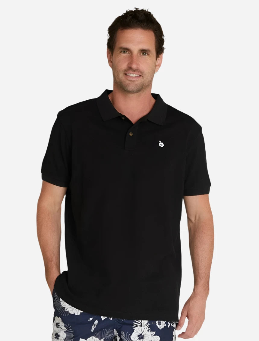 A male model wearing the Okanui Classic Polo Shirt in black.