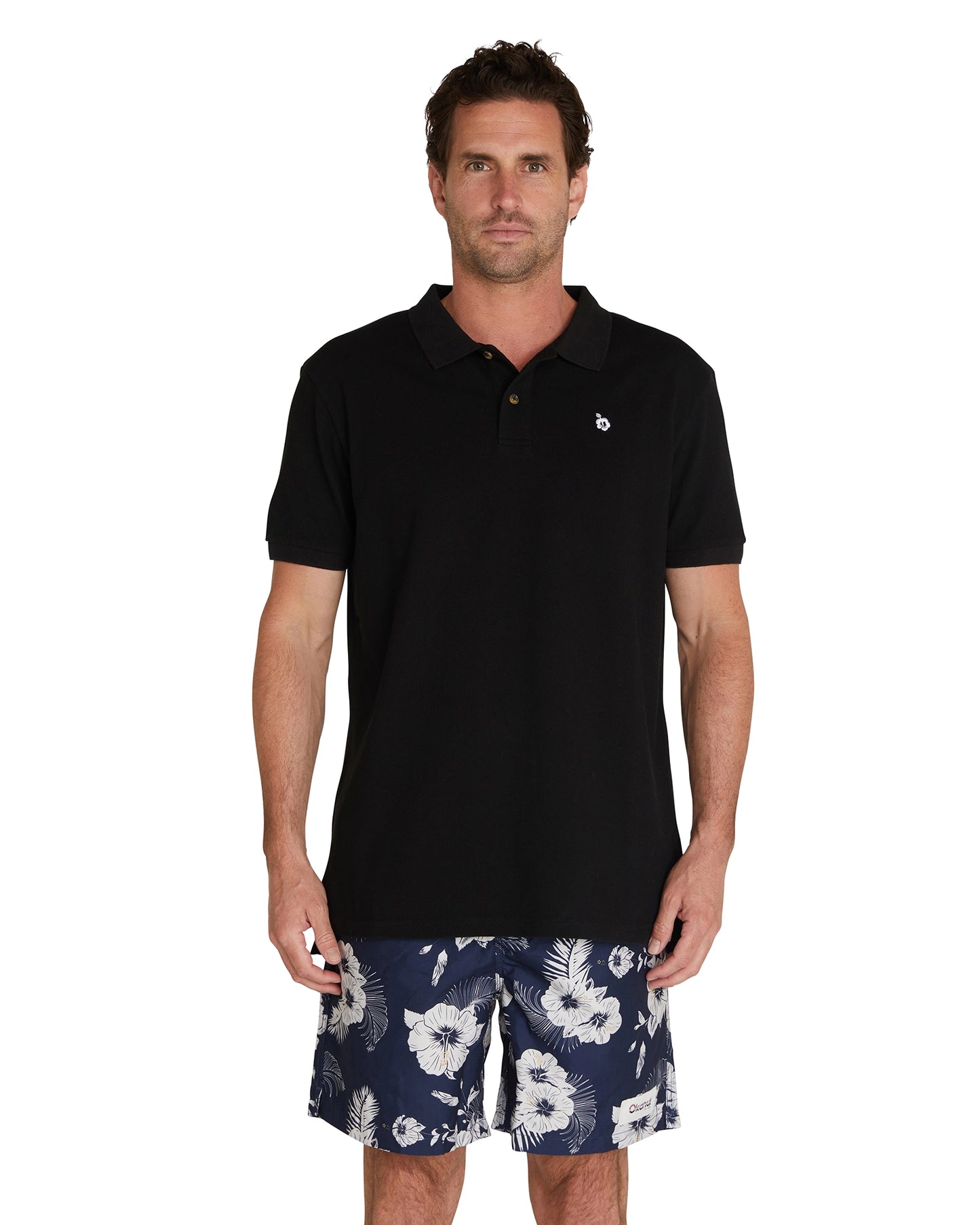 Front view of a male model wearing the Okanui Classic Polo Shirt in black colour.