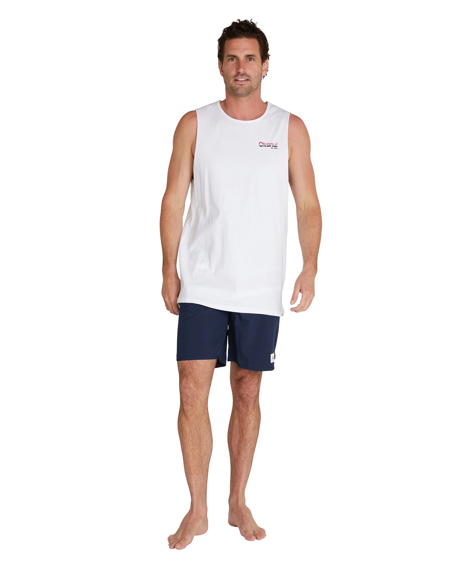 A male model wearing a navy short and the Okanui Classic Logo Tank Top in white color.