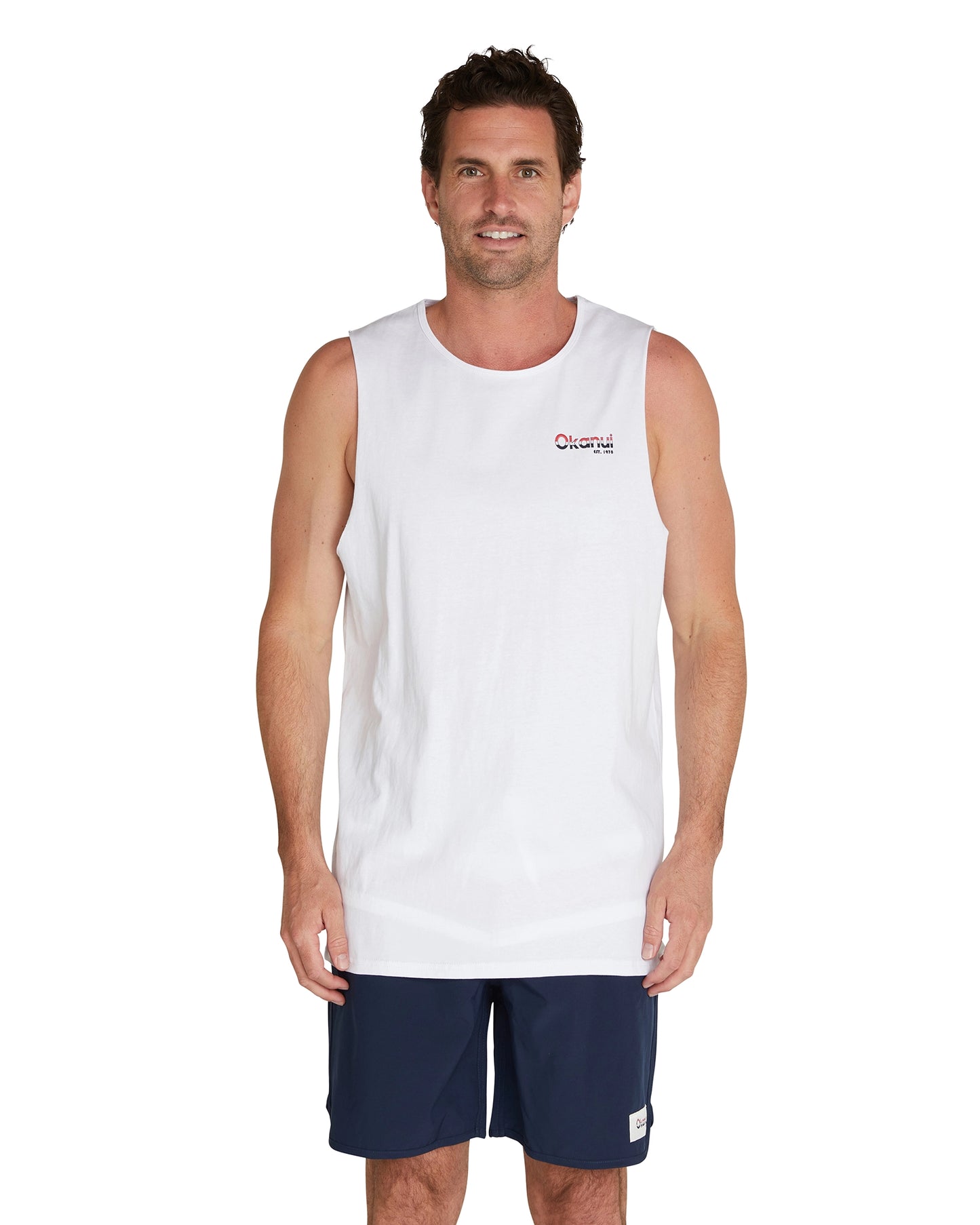 A closer view of the male model wearing the Okanui Classic Logo Tank Top showcasing the Okanui logo on the left chest.