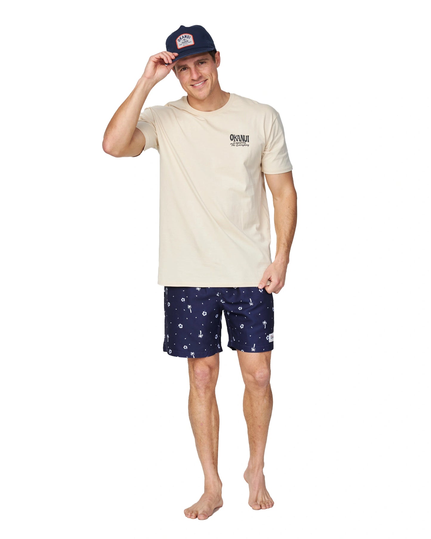 Full body of a male model wearing the Okanui Classic Lock up snapback trucker cap in Navy