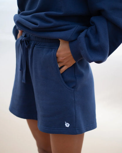 Womens fleece short in navy blue color showing the side pocket.