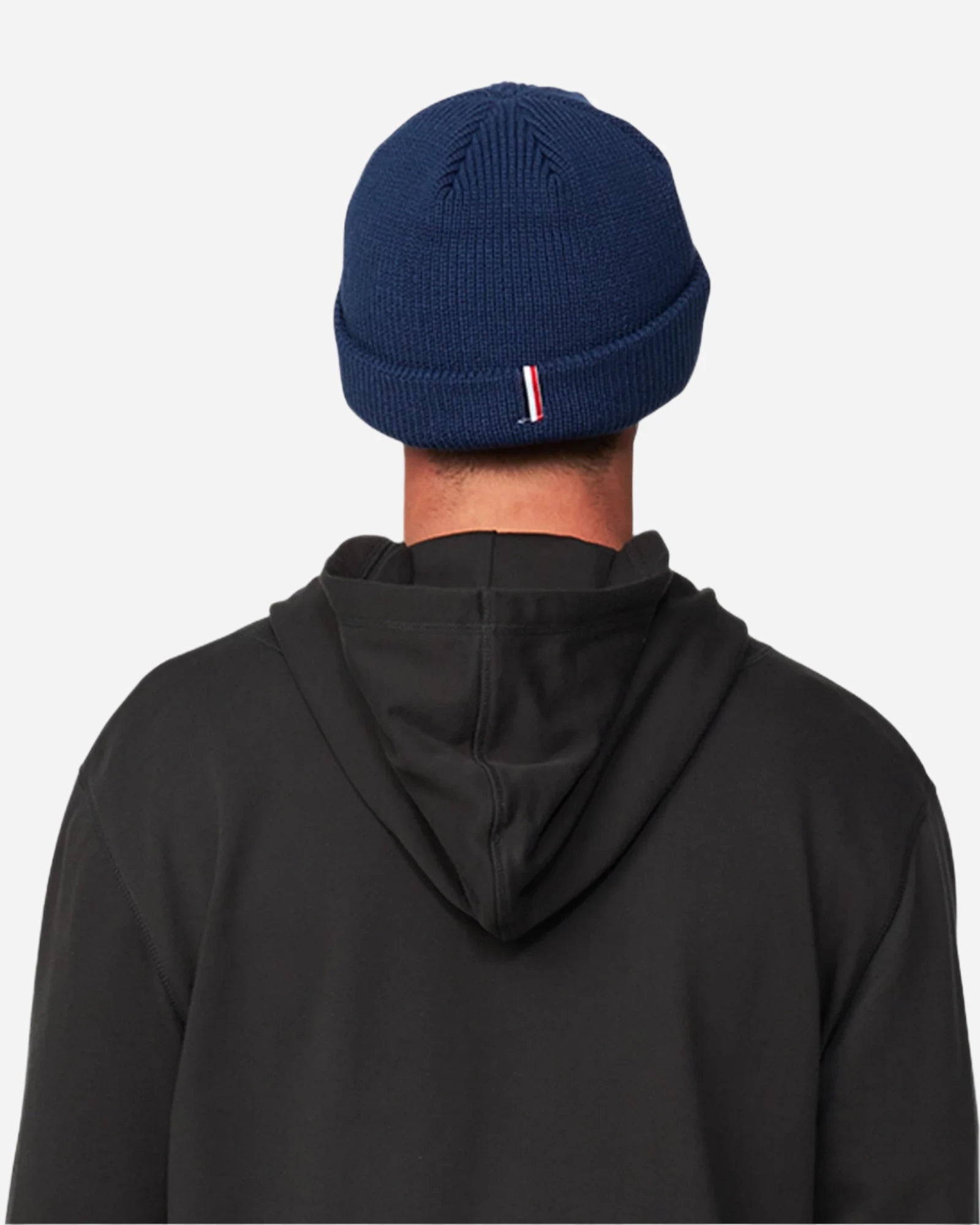 Back view of a male model in hood wearing the Okanui Fisherman's Rib Knit Beanie Hat for Men in Navy Color