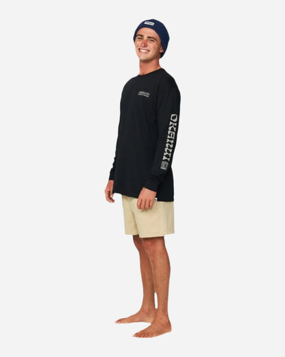 Full body of a male model in black long sleeves wearing the Okanui Fisherman's Rib Knit Beanie Hat for Men in Navy Color