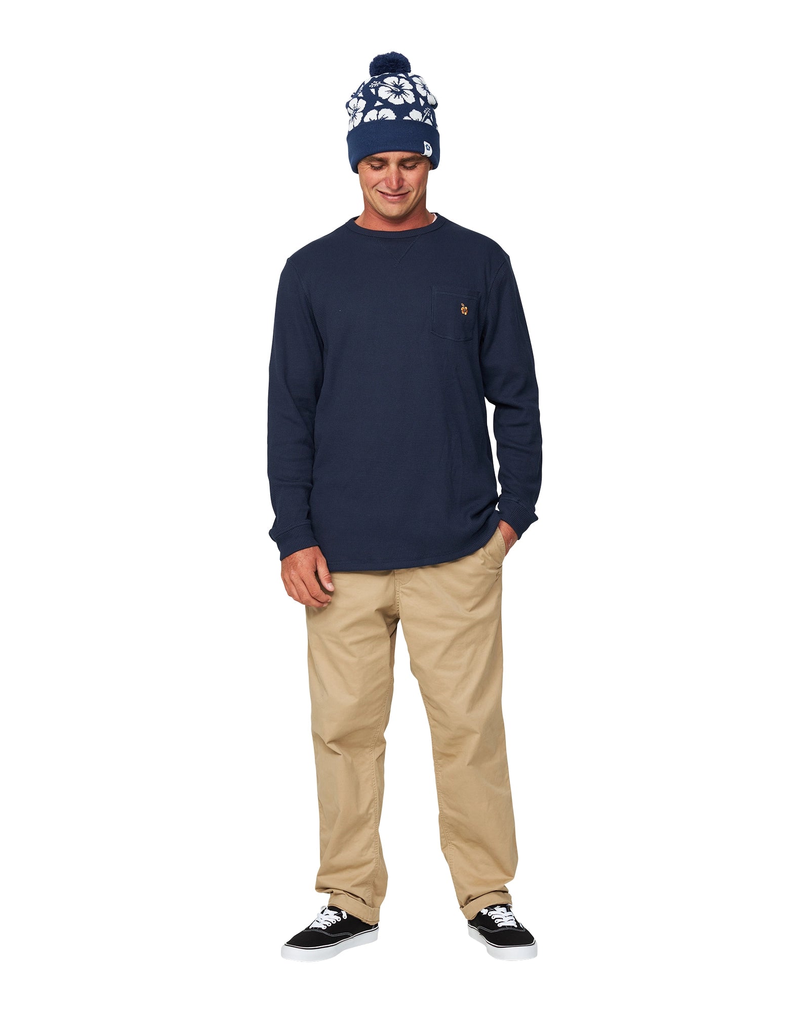 Male model in blue long sleeve shirt and trousers paired with Okanui Hibiscus Rib knit Pom Pom beanie hat in Navy color