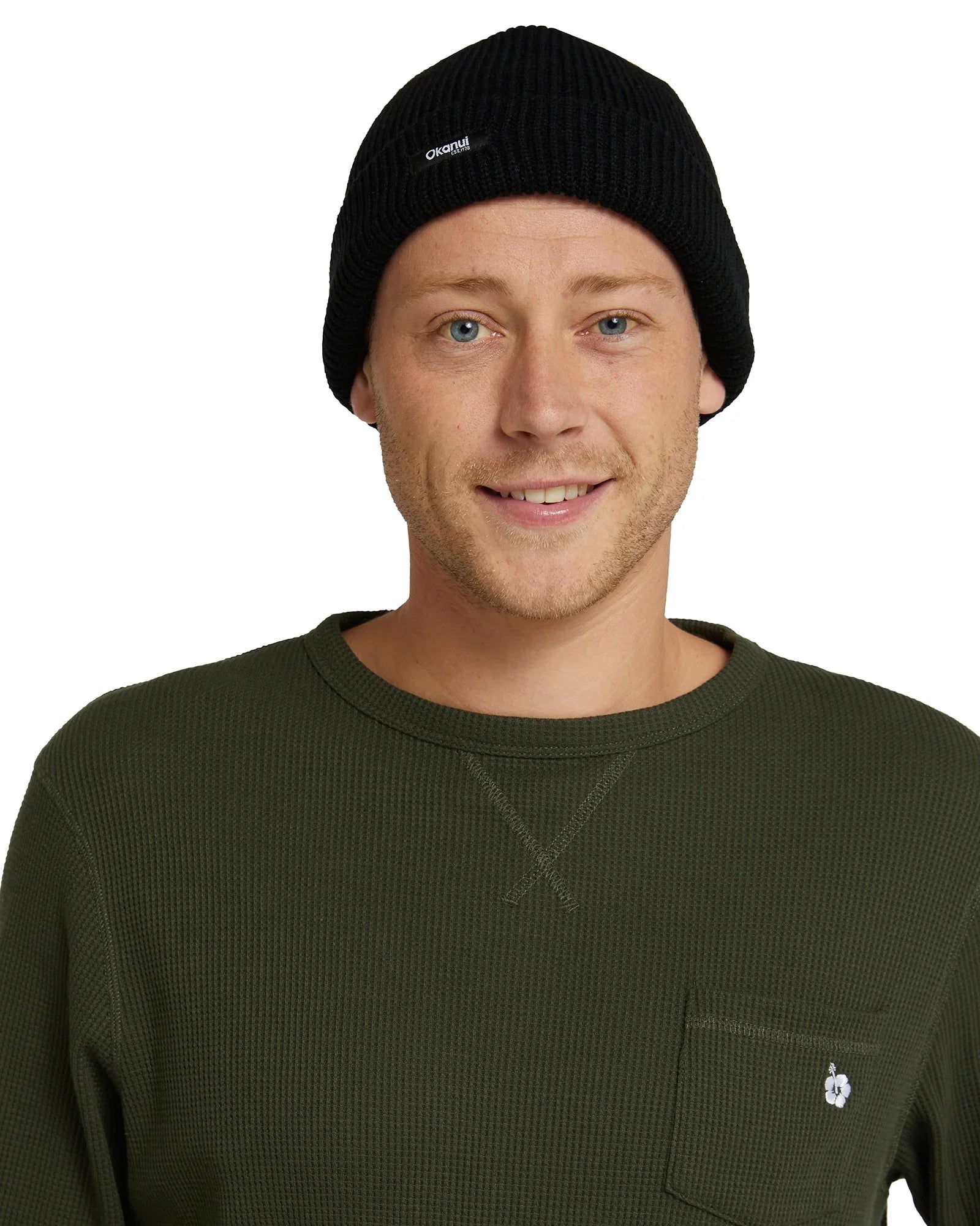 Front view of a male model wearing the Okanui Fisherman's Rib knit beanie hat anti anti black variant