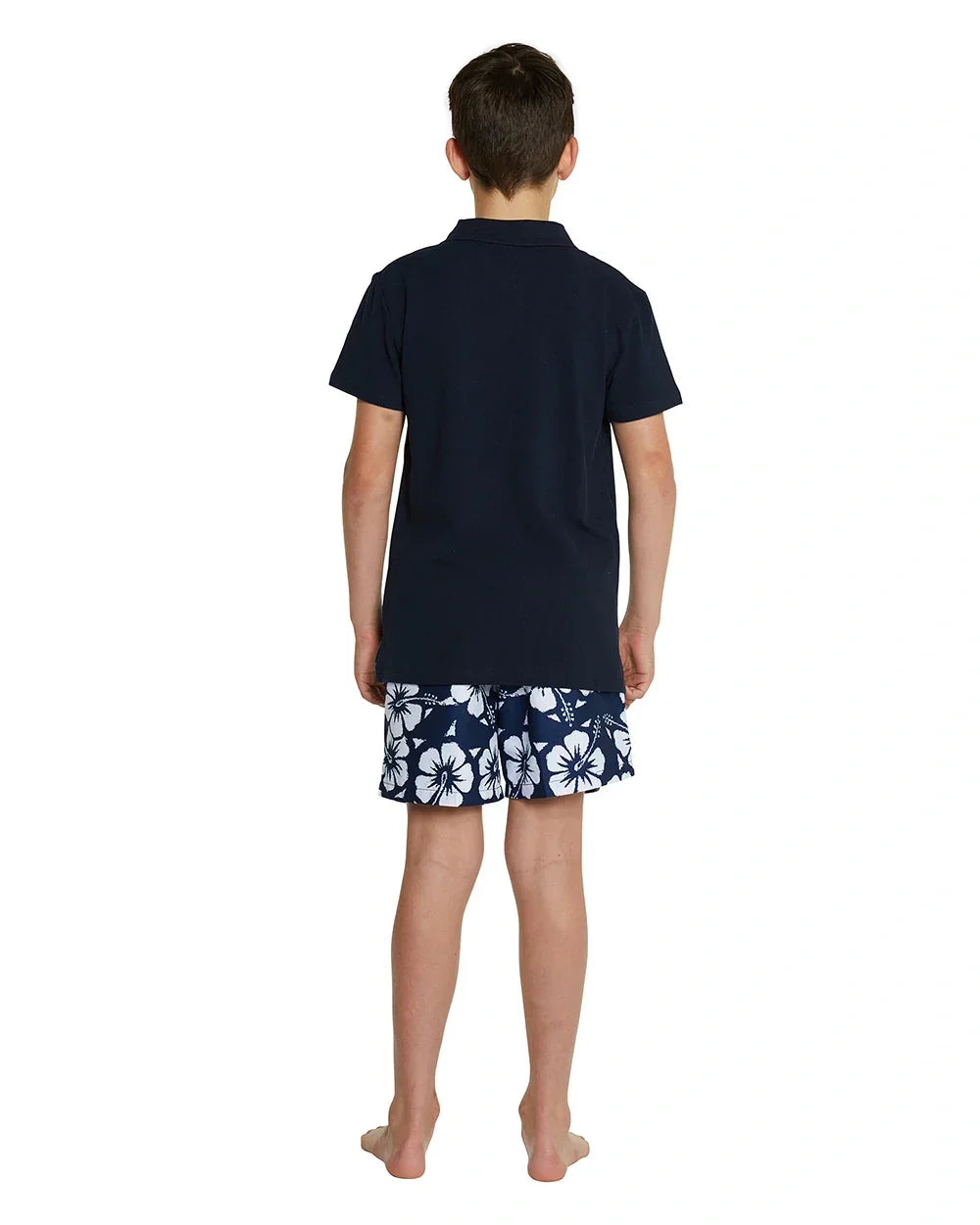 A back view of a boy wearing the Okanui classic polo shirt in Navy color