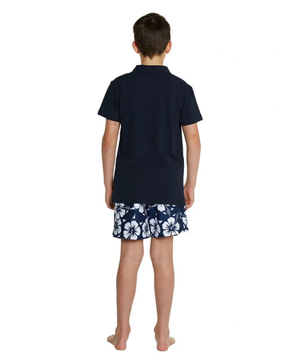 A back view of a boy wearing the Okanui classic polo shirt in Navy color