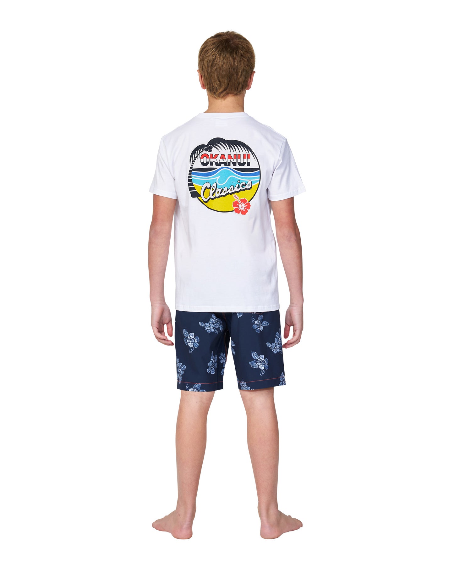 Full body back view of a boy wearing the Okanui classic white cotton t-shirt