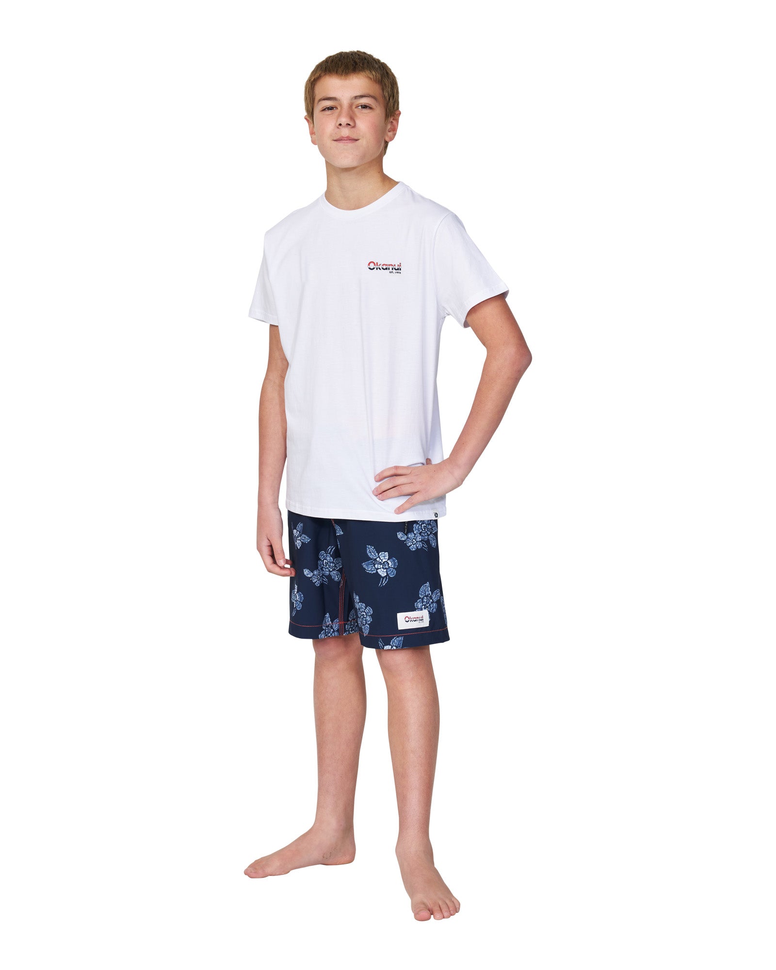 Full body front view of a boy wearing the Okanui classic white cotton t-shirt