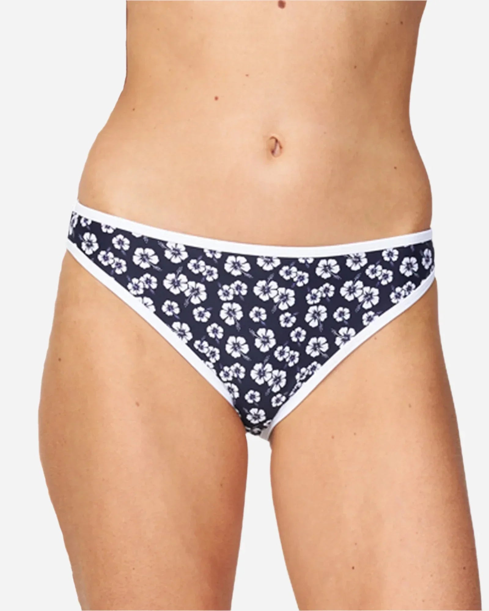 A woman wearing a brief bikini bottom in hibiscus navy showing the front details. 