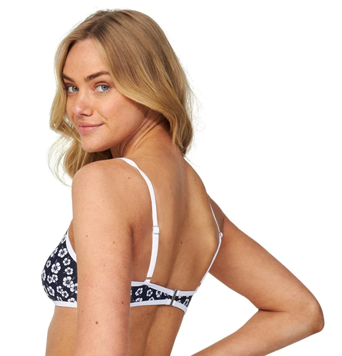 Left angled view of a female model wearing the Okanui scoop necktop Liberty Hibiscus Navy Swim top