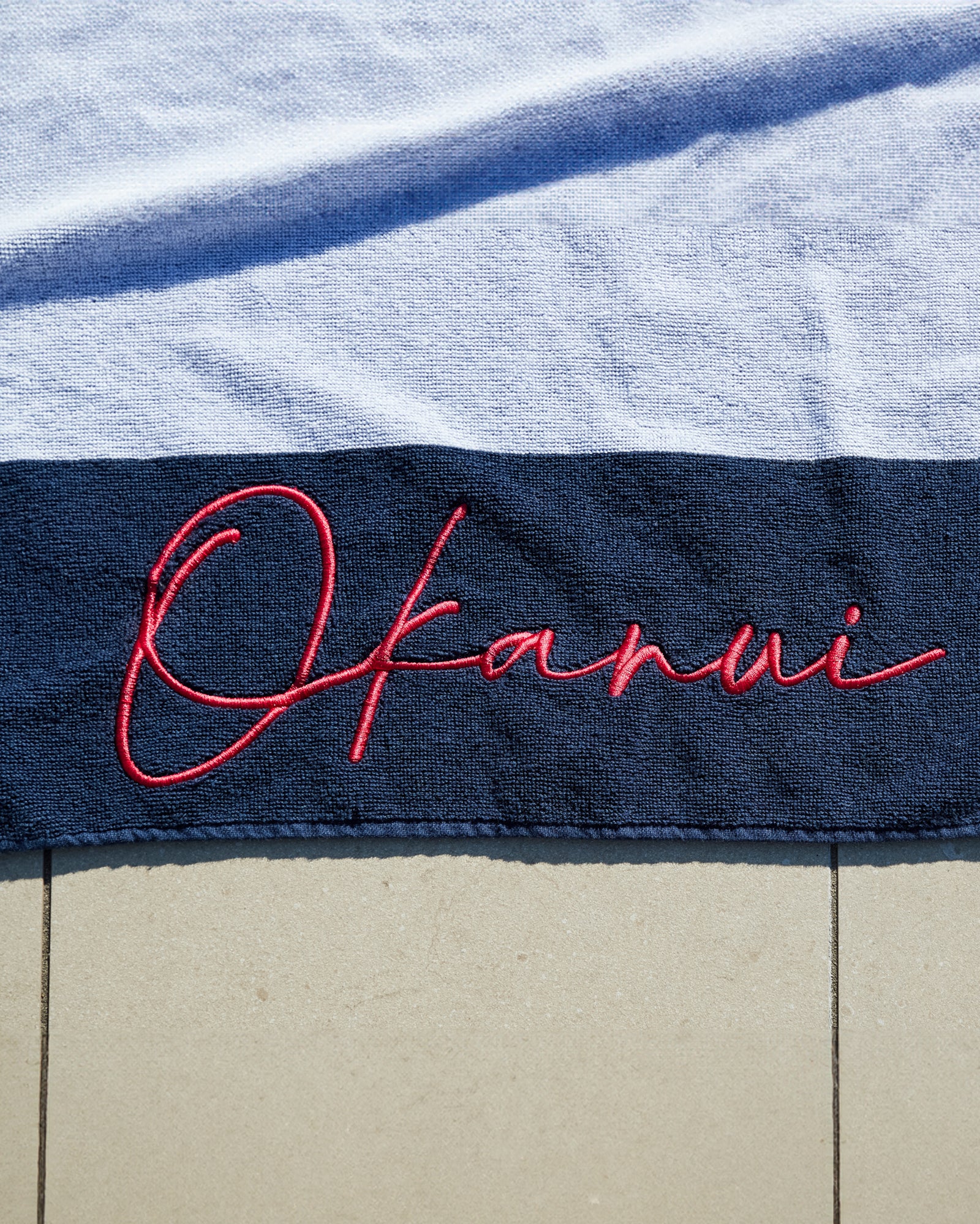 Logo of the Okanui classic stripe navy towel