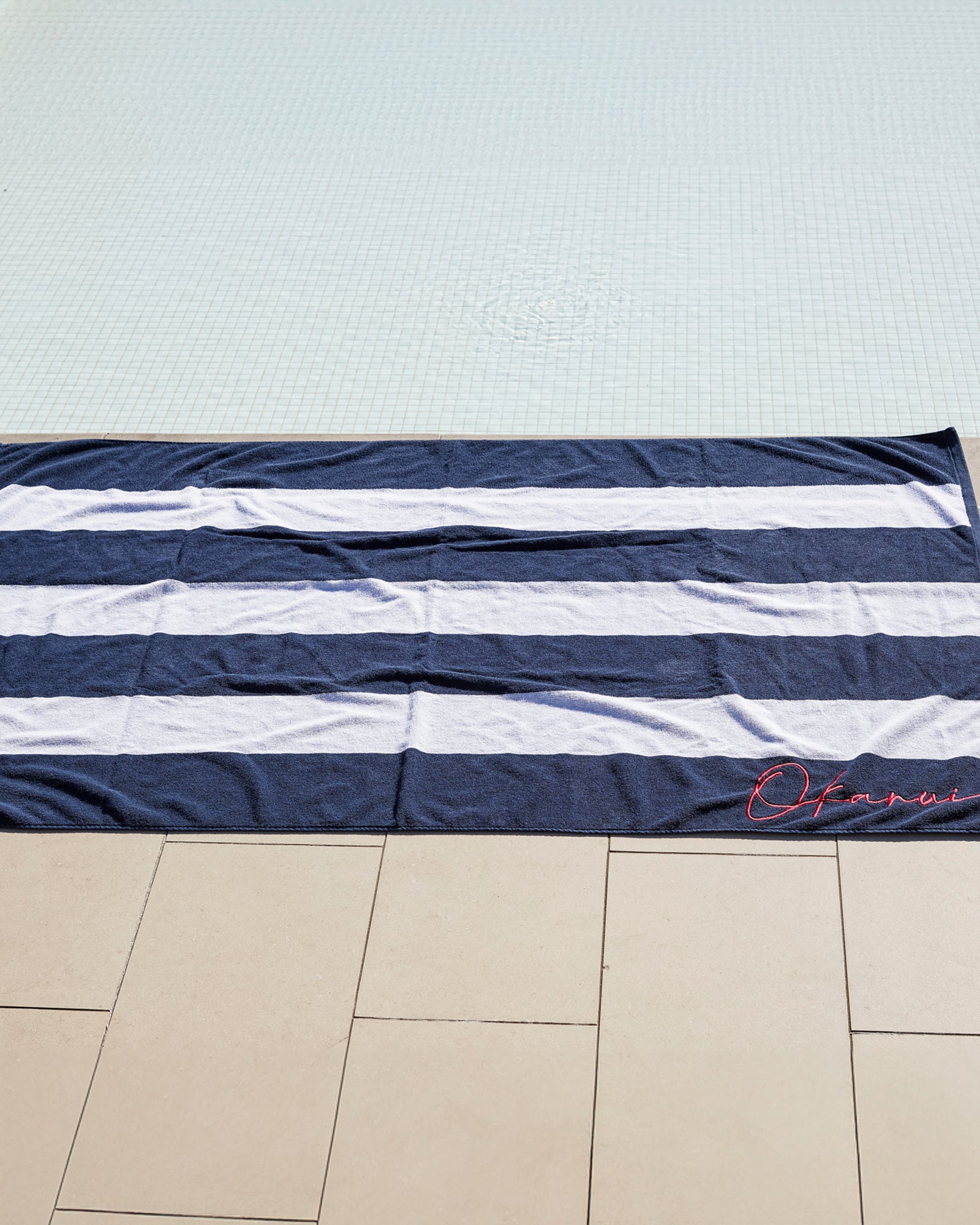 Upside part of the Okanui stripe navy towel