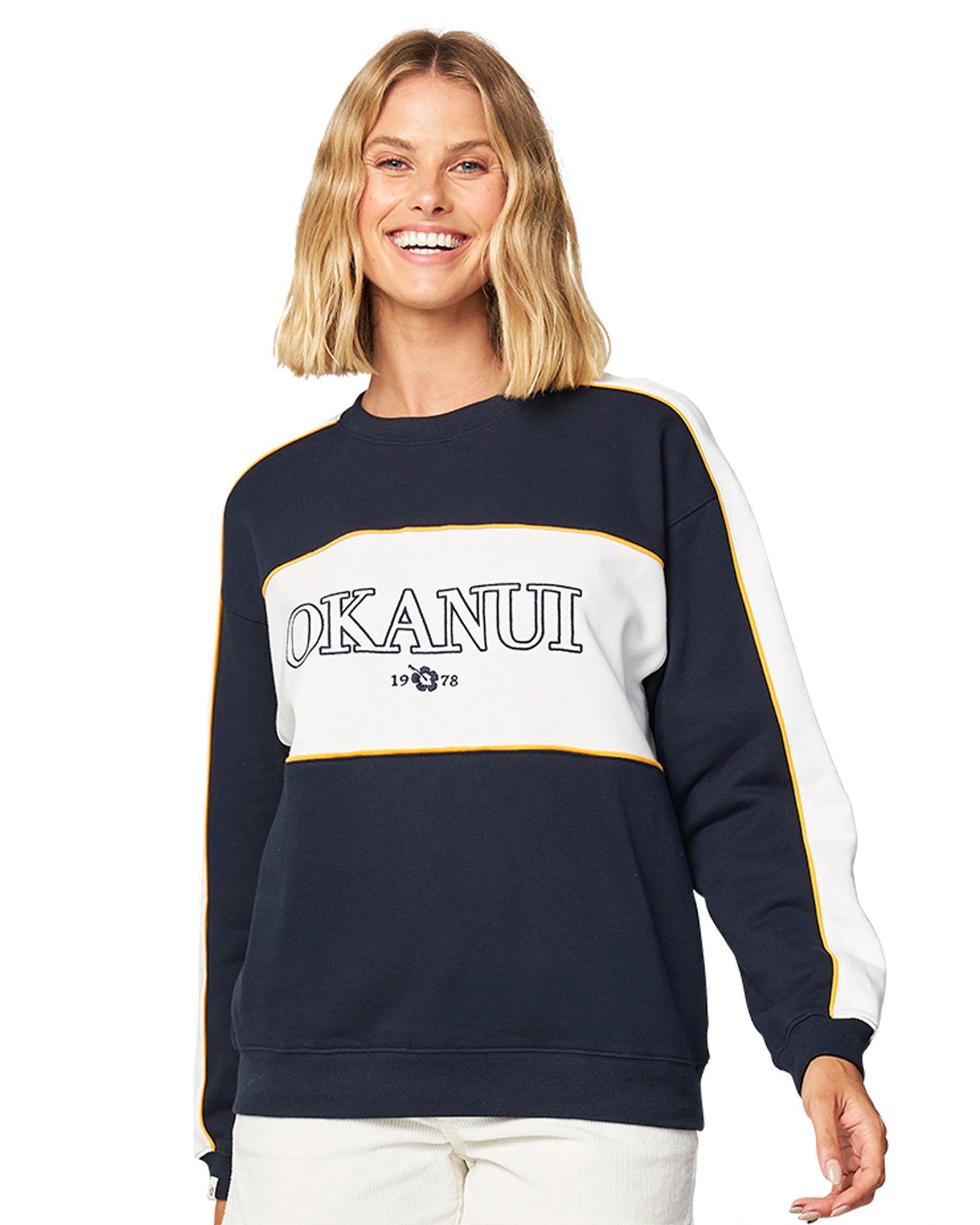 Womens varsity sweater in white and navy blue color showing the Okanui logo in the middle. 