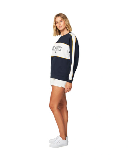 Okanui Womens varsity sweater in white and navy blue color showing the side view.