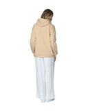 Womens winter hoodie in natural color with white sneakers and pants showing the back part.