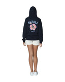 Women's navy-blue fleece hoodie with white pants and sneakers showing the back part. 