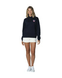 Women's navy-blue fleece hoodie with white pants and sneakers. 