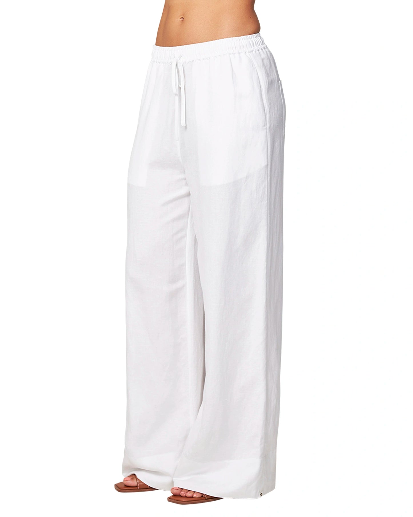 Angled front view of the Okanui wide leg linen beach pants in white color