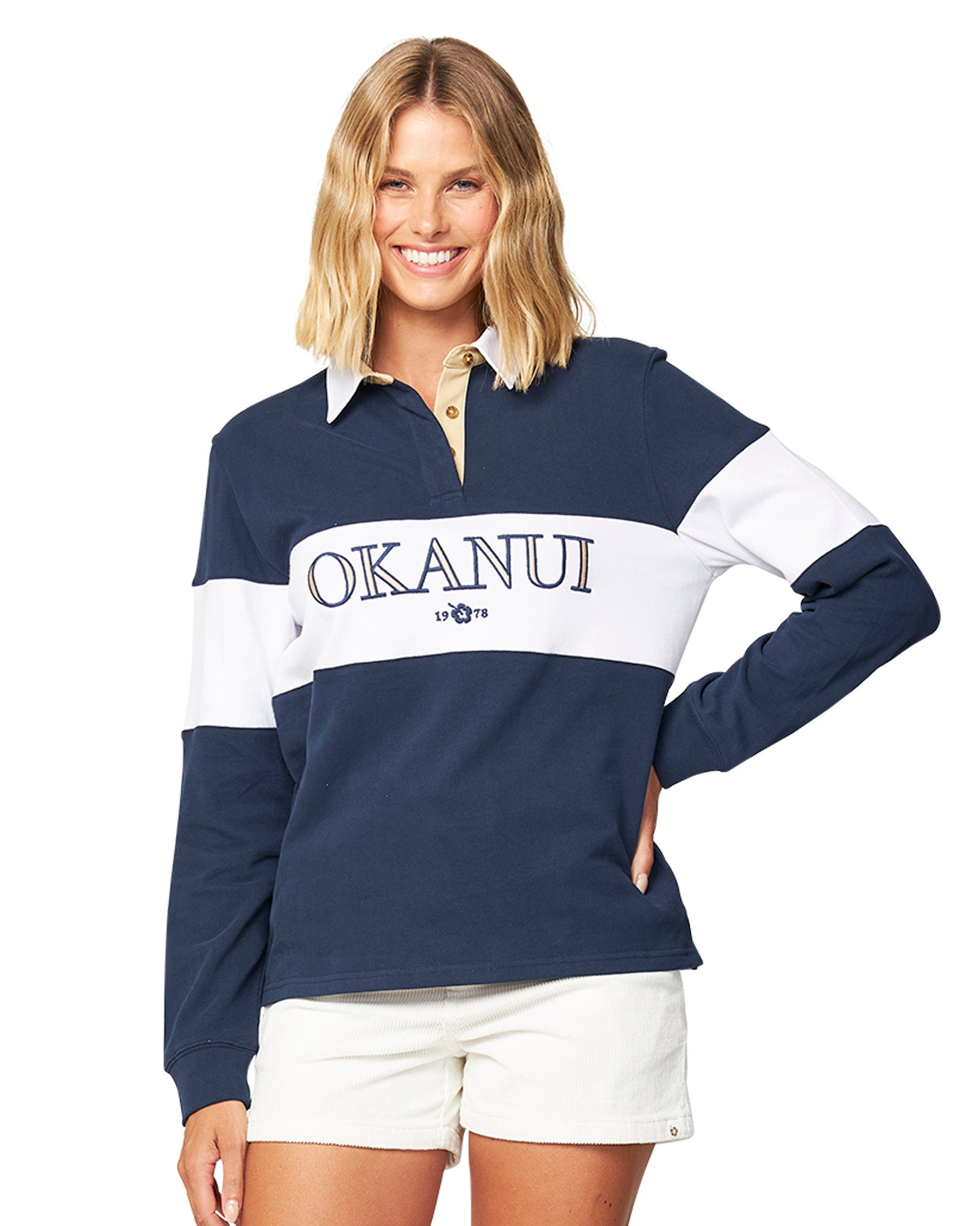 Front view of a female model wearing the Okanui Baywalk Corduroy walking shorts in Natural variant paired with Okanui rugby top jumpers