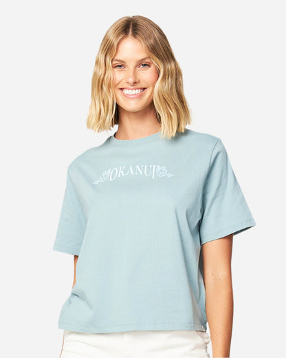 Front view of a female model wearing the Okanui Tour Cropped cotton T-shirt in Sage variant