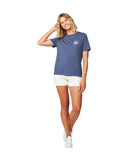 Full body front view of a female model wearing the Okanui Ikon cotton T-shirt in Washed Navy color