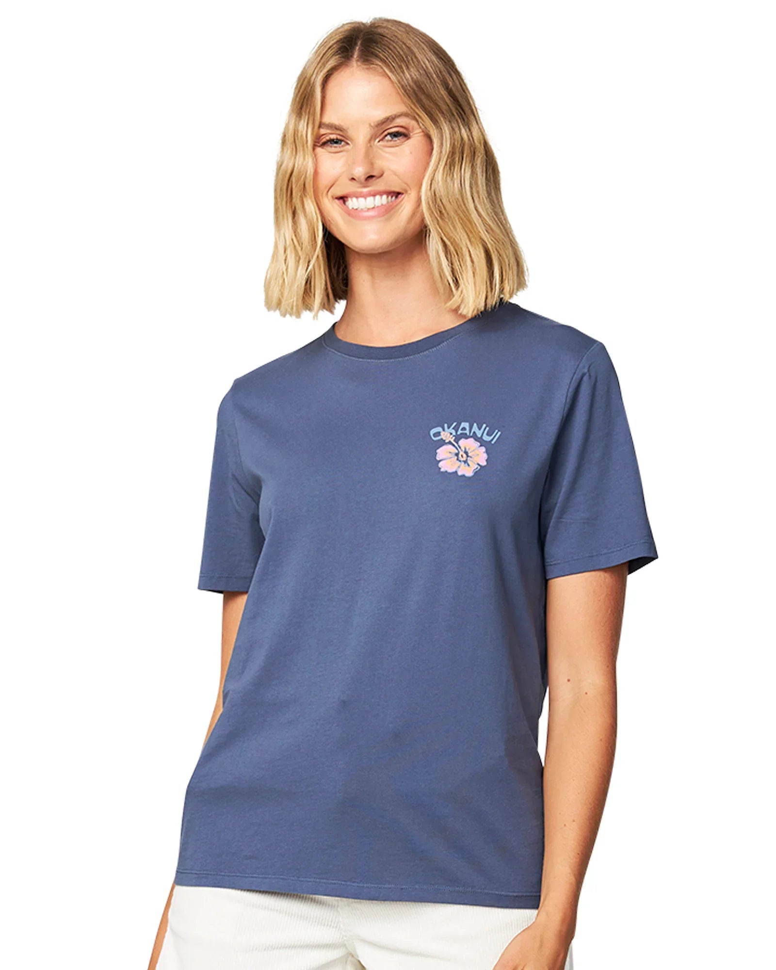 Front view of a female model wearing the Okanui Ikon cotton T-shirt in Washed Navy color