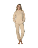 Full body front view of a female model wearing a natural color jacket paired with the Okanui jogger track pants in natural color