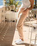 Close up front view of the Okanui jogger track pants in Natural color