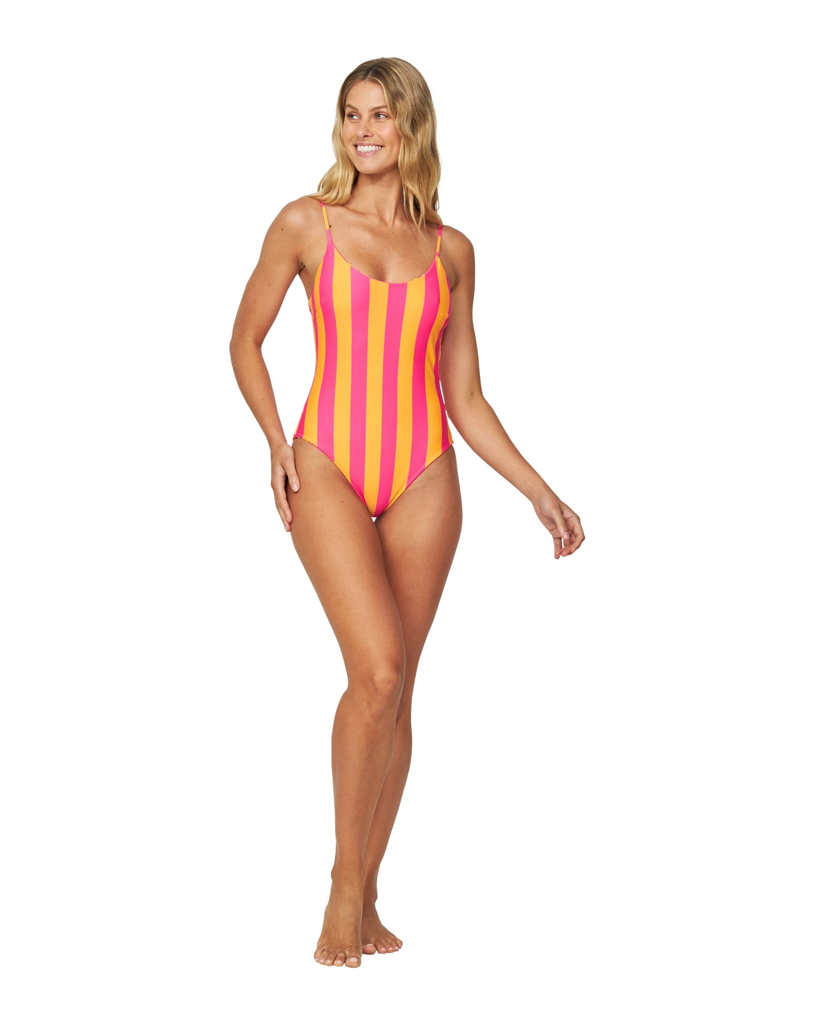 A woman is dressed in a one-piece swimsuit with adjustable straps and melon pink stripes.