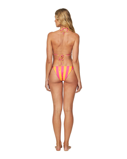 A woman wearing a melon pink bikini top with the back view. 