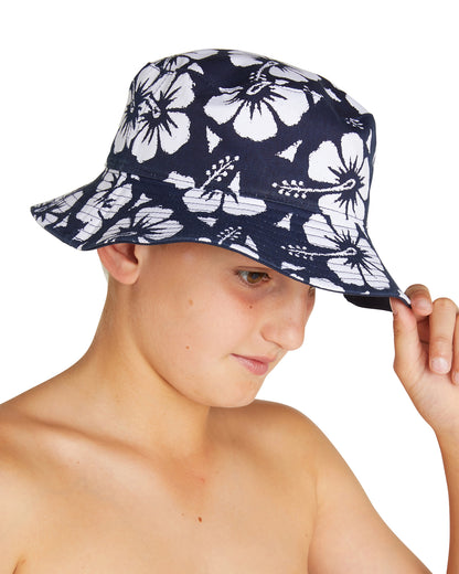 A boy wearing the Okanui reversible bucket hat, crafted from 100% premium cotton in White variant