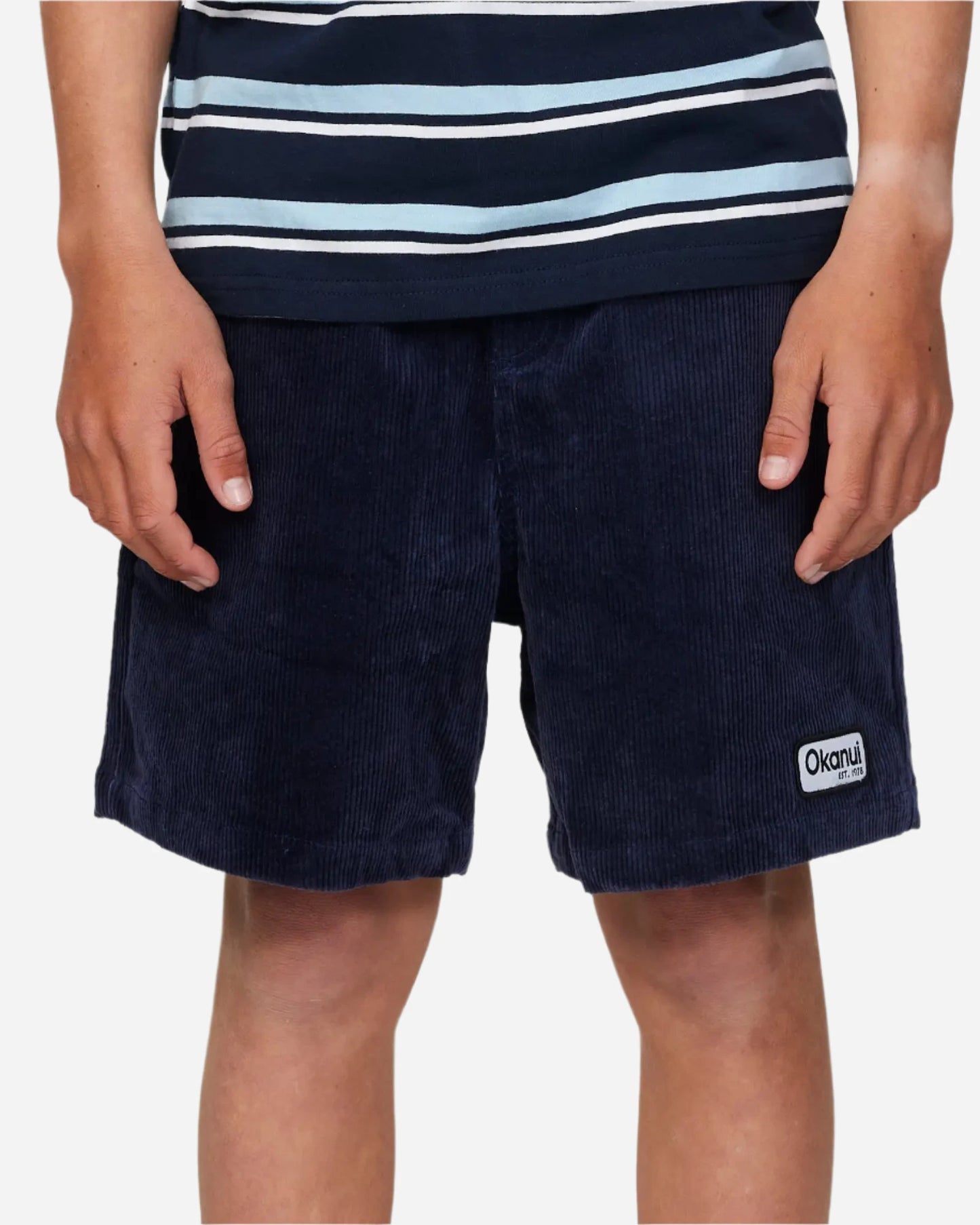 Front view of a boy model wearing the Okanui Corduroy Walk Short in Iron Navy