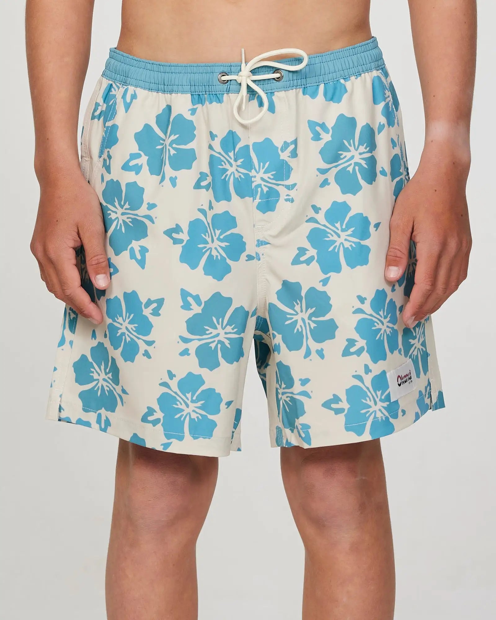 Front view of a boy model wearing the Okanui Waterworld Stretch Swim Short for Boys in Stone Aqua