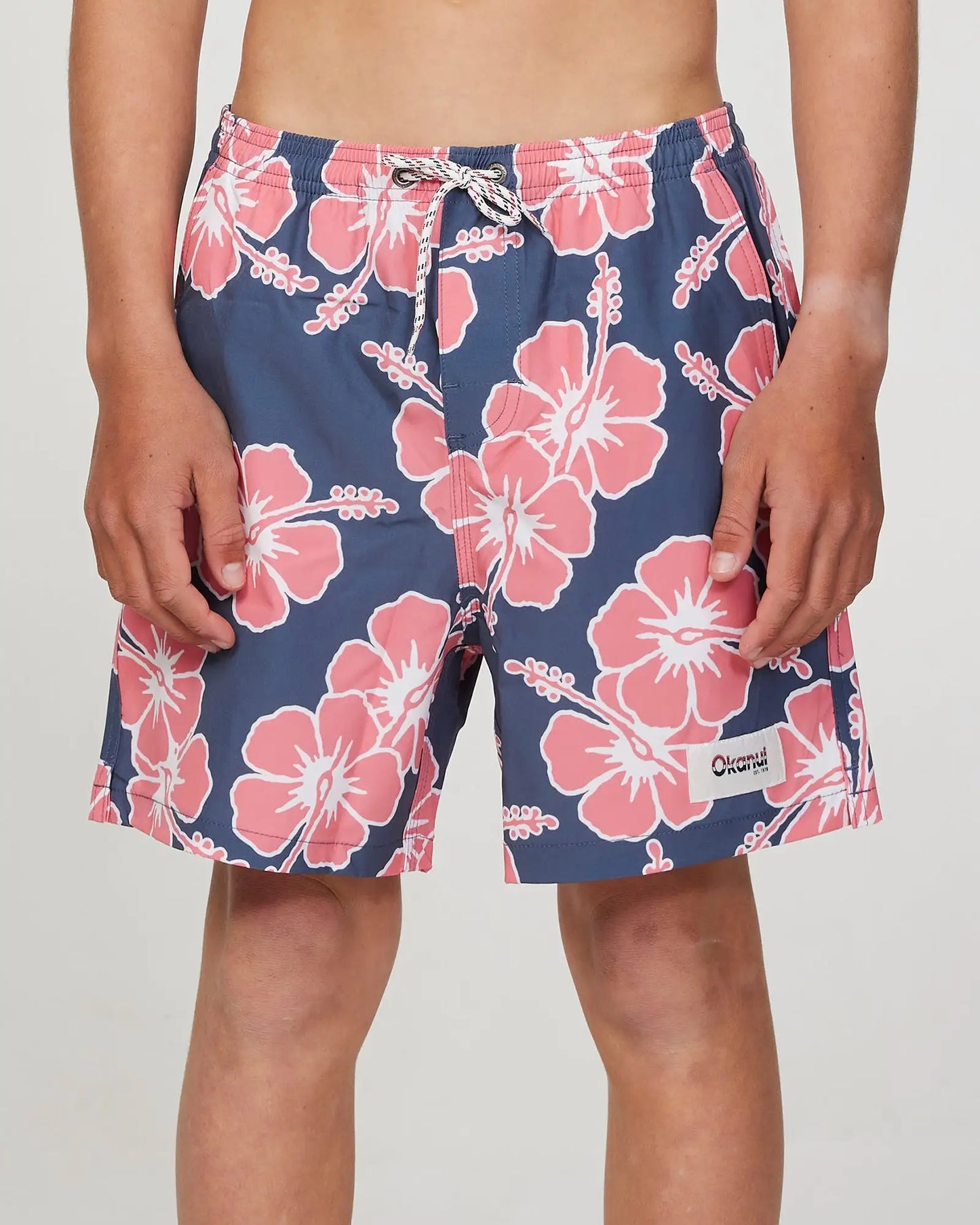 Front view of a boy model wearing the Okanui Way Back When Stretch Swim Short for Boys in Iron Pink