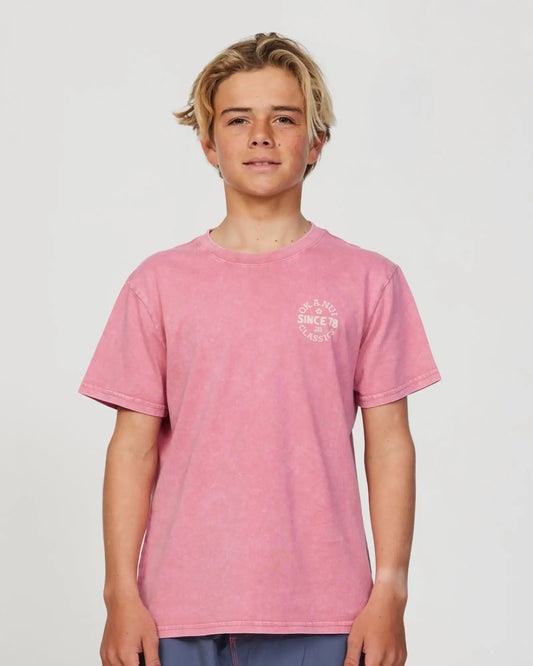 Closeup front view of a boy model wearing the Okanui Stamp Tshirt for boys in Washed Rose