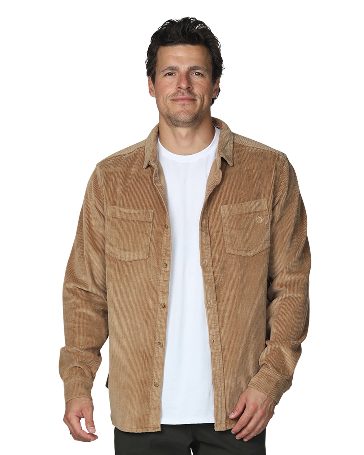 Front view of a male model wearing the Okanui Mens long sleeve corduroy jacket in sand paired with an inner white shirt