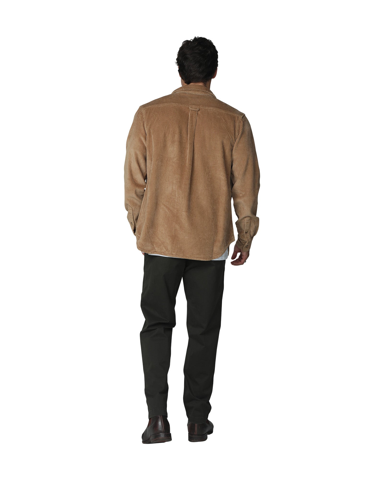 Full body back view of a male model wearing the Okanui Mens long sleeve corduroy jacket in sand paired with a black trouser