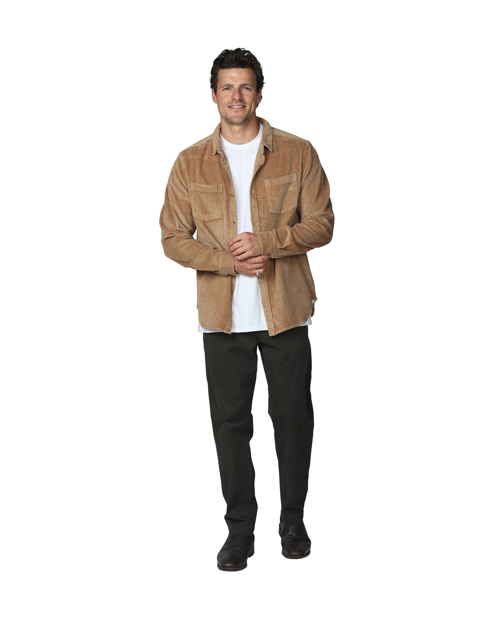 Full body front view of a male model wearing a black trouser paired with the Okanui Mens long sleeve corduroy jacket in sand