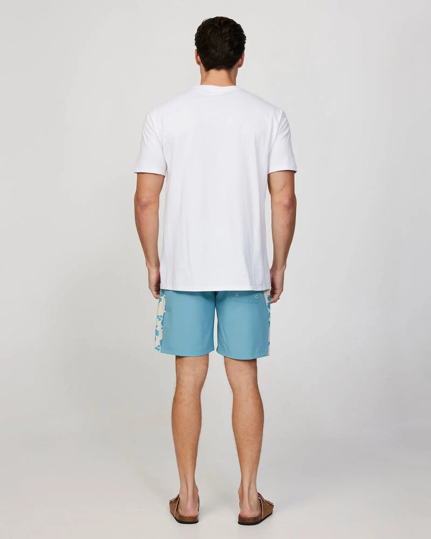 Full body back view of a male model wearing the Okanui Mens Waterworld boardrider board short in Aqua