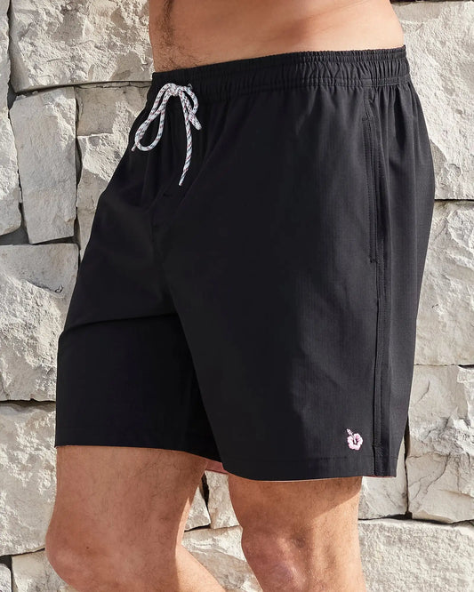 Left side view of the Okanui Mens Onboard stretch swim short in Black