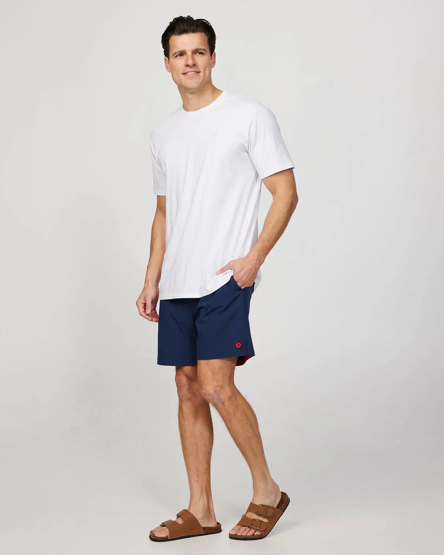 Full body left side view of the Okanui Mens Onboard stretch swim short in Navy