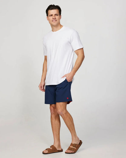 Full body left side view of the Okanui Mens Onboard stretch swim short in Navy